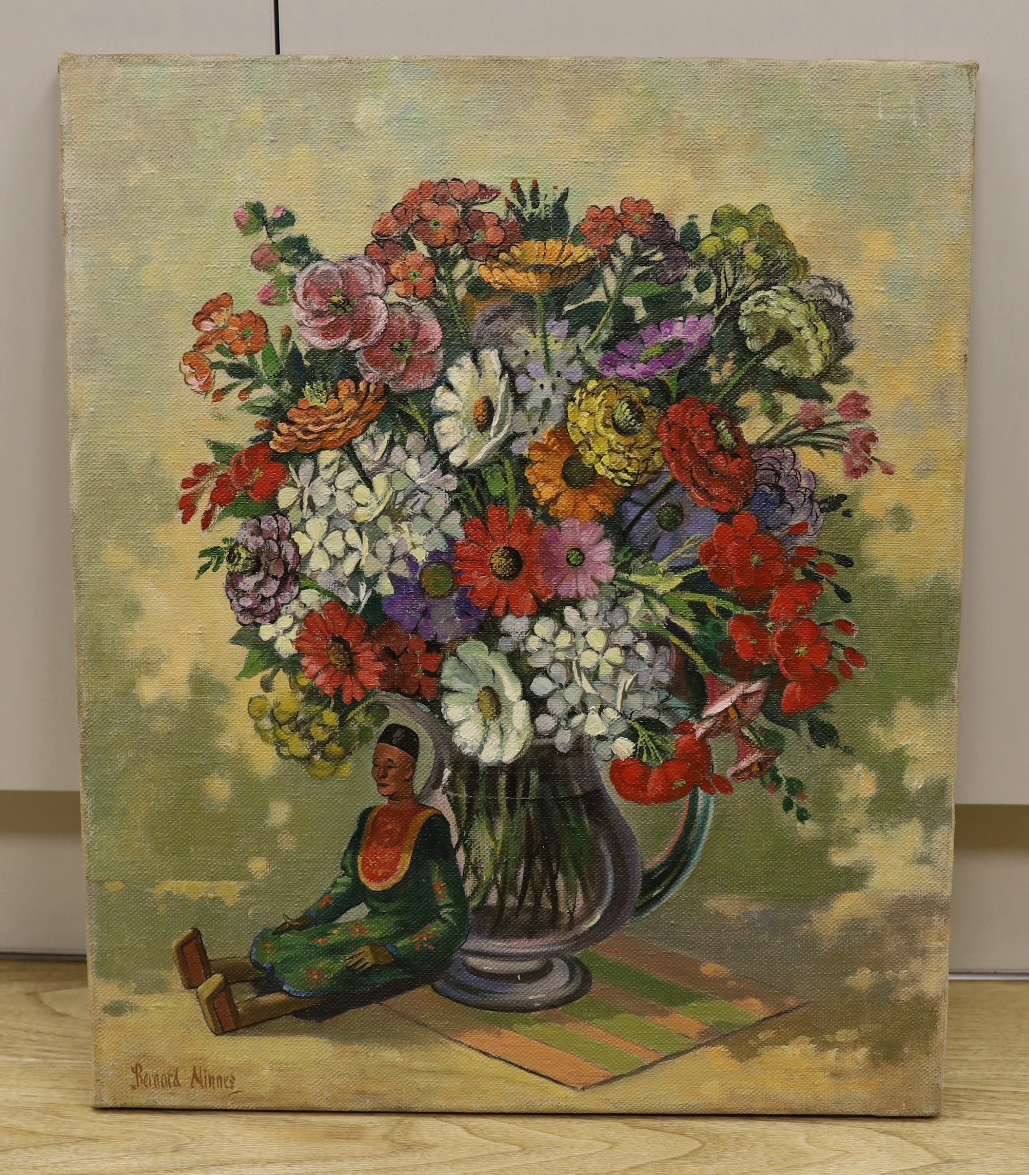 Bernard Ninnes (1899-1971), oil on canvas, Still life with Indonesian doll beside a vase of flowers, signed, 60 x 51cm, unframed